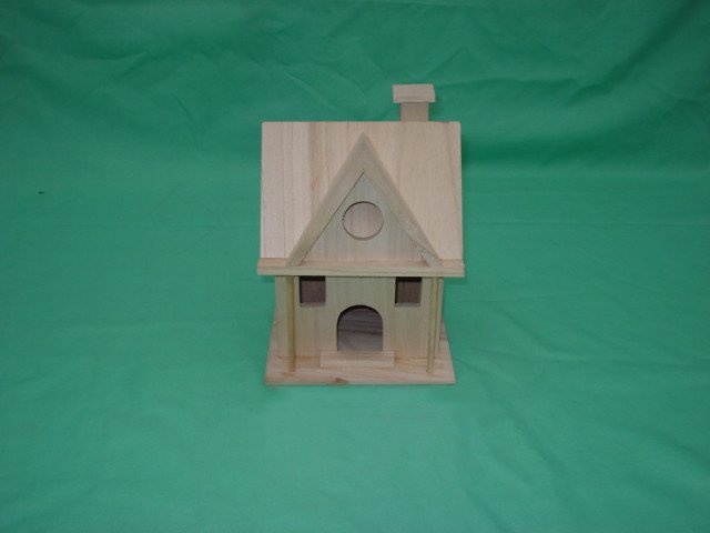 Two-story A-frame wooden bird house with chimney, round attic window, side windows and arched door