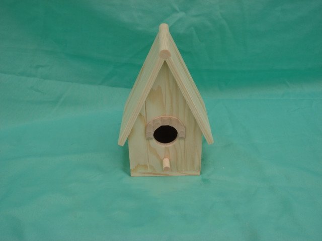 A-frame wooden bird house with arched-top entrance and small wooden perch