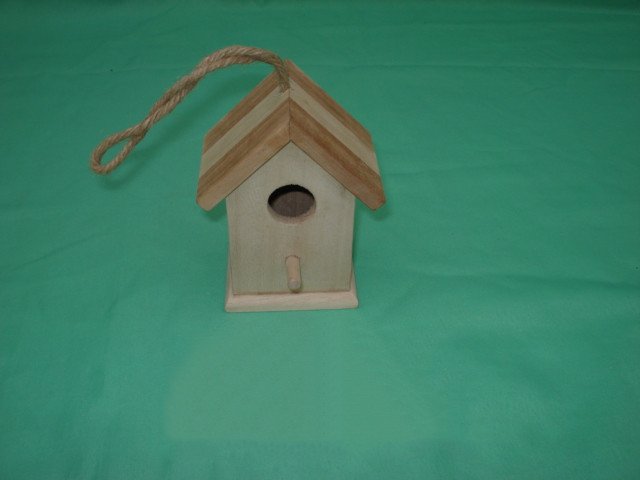 Small wooden bird house with two-tone striped roof, rope hanger and round entrance with perch