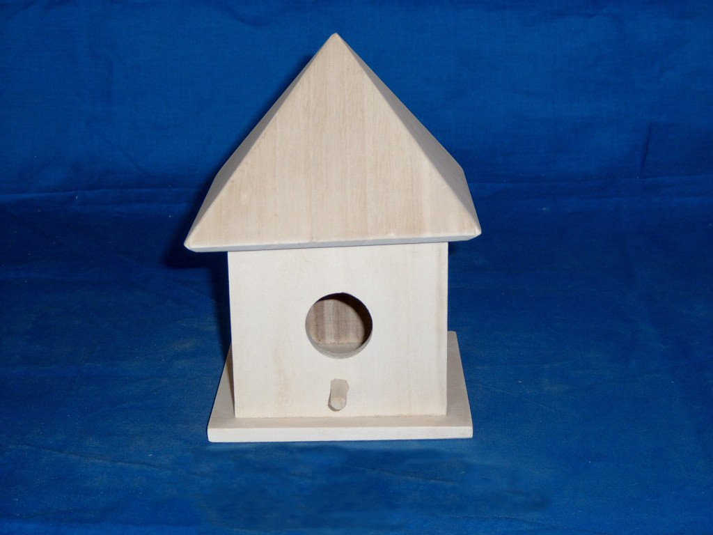 Wooden bird house with pyramid roof, circular entrance and small wooden perch