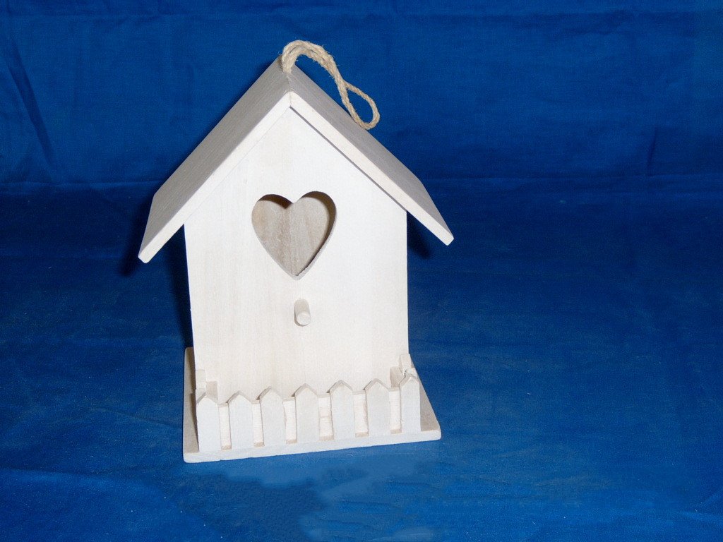 White-painted A-frame wooden bird house with heart cutout, picket-fence base and rope hanger