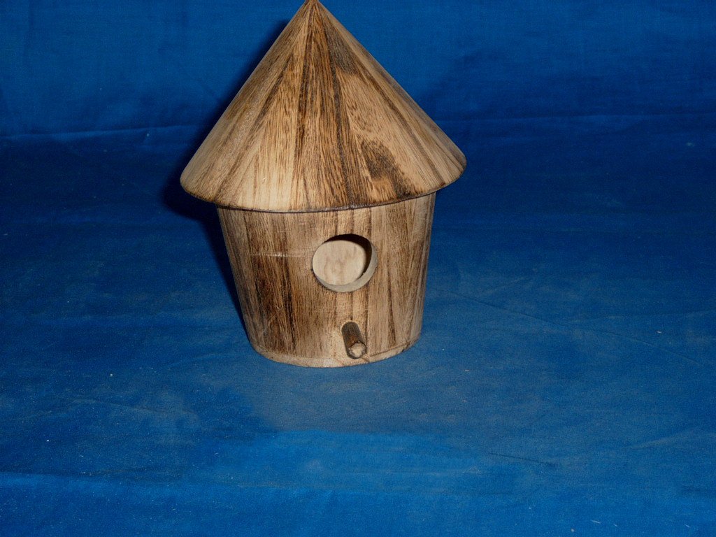 Round tower-style wooden bird house in driftwood finish with large circular entrance and perch