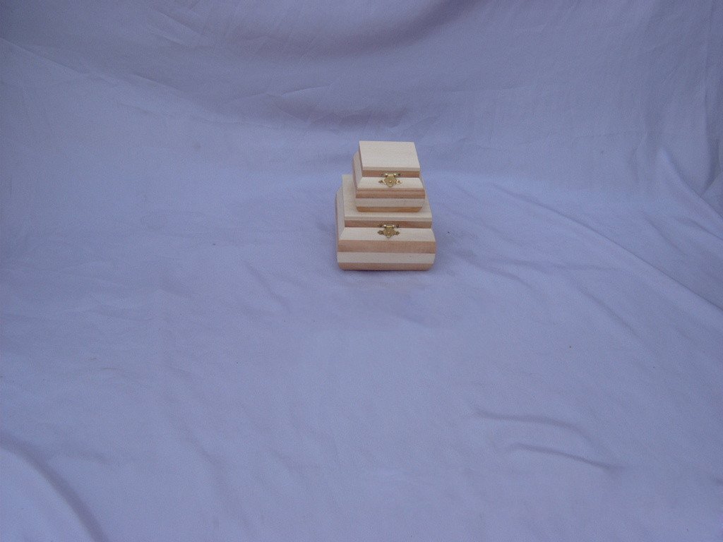 Stacked set of two to three nested square wooden boxes with alternating light/dark horizontal stripes and brass clasps
