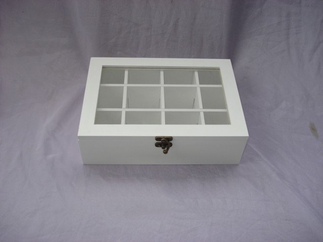 White wooden box with glass window top showing 12 grid compartments inside, antique brass latch