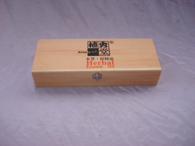 Long flat natural-pine wooden box with Chinese character print reading Herbal Essential Oil, small silver latch