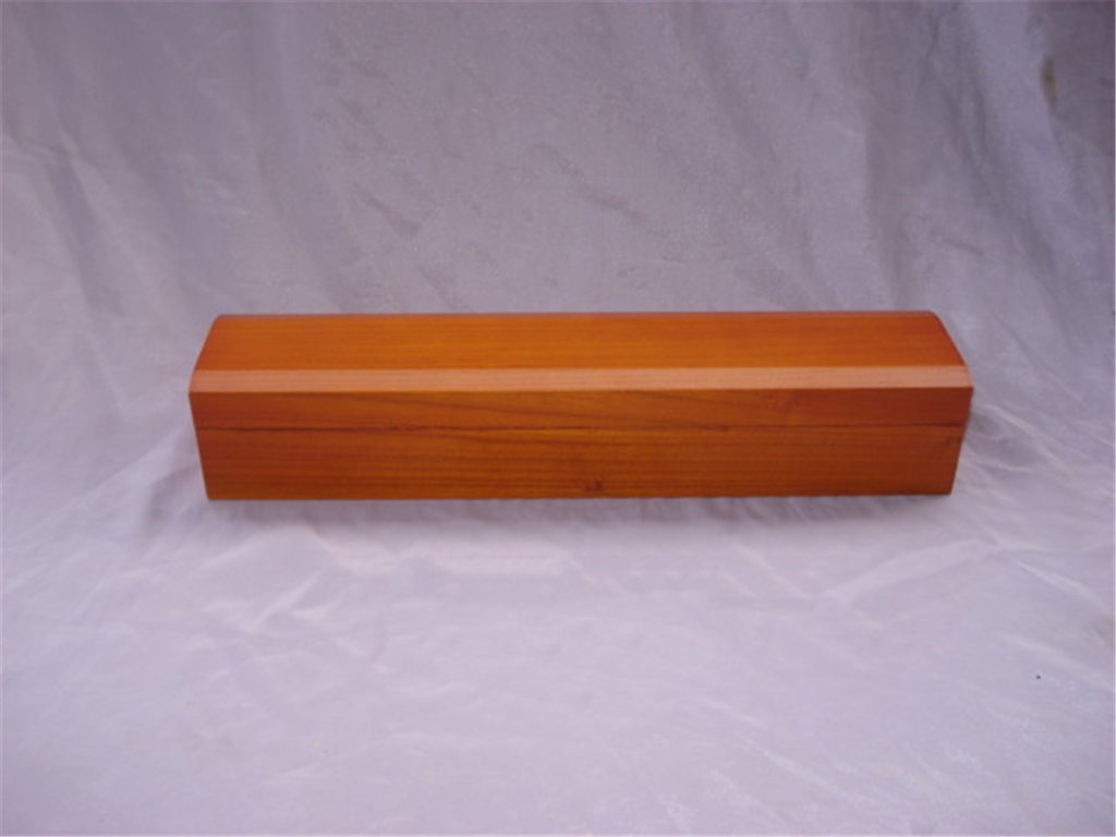 Long flat cedar orange-toned wooden box with no visible hardware, hinged lid