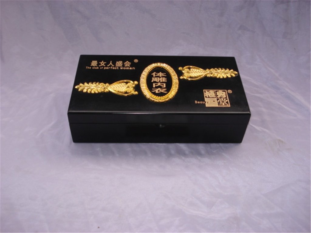 Black wooden box with gold tone decorative carving and Chinese character logo reading perfect woman, brass latch