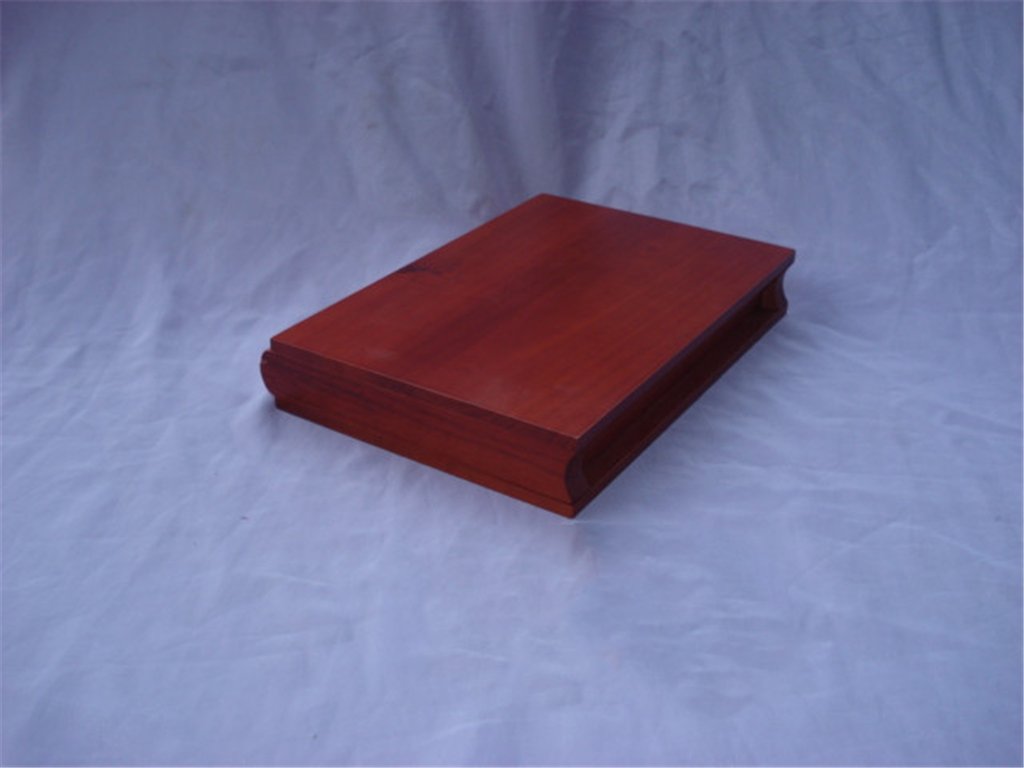 Long flat rosewood-style wooden box with curved arched lid edges and no visible hardware