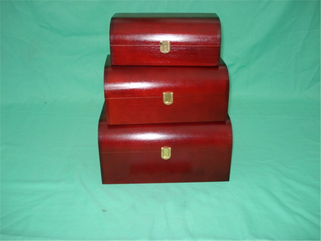 Three-piece nested domed wooden box set in dark red mahogany finish with gold latches