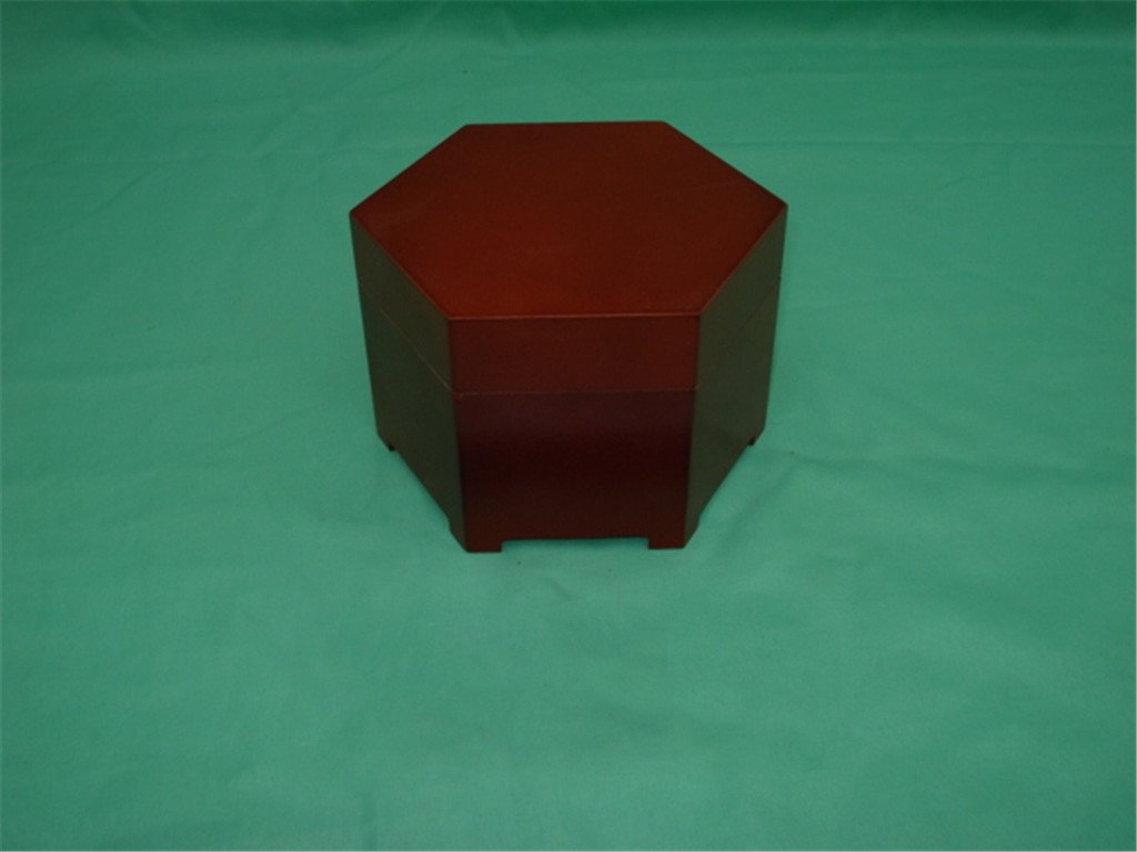 Hexagonal wooden box in dark red mahogany finish with no visible hardware