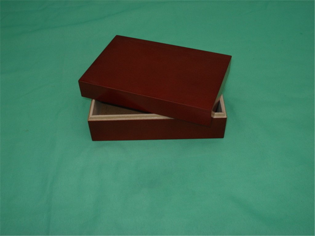 Open red lacquered wooden box showing the base with gray interior lining, no hardware