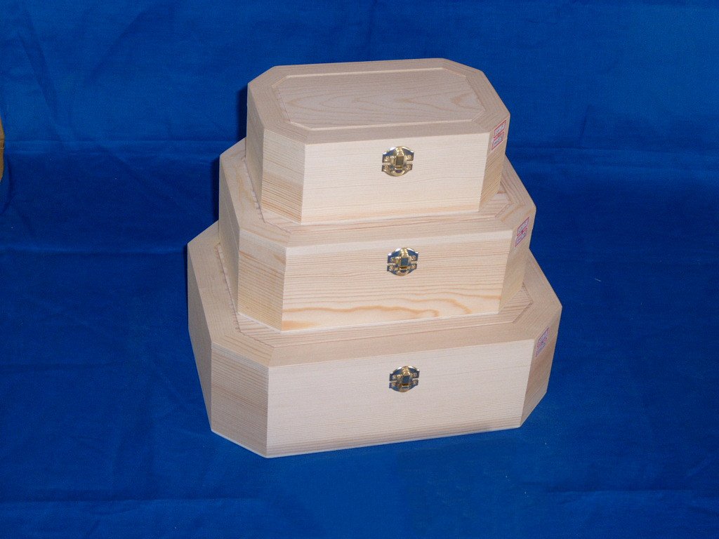 Three-tier nested octagonal wooden box set in natural pine with brass latches and small product labels