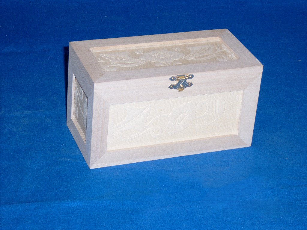 Natural-wood wooden jewelry box with carved floral pattern on lid and front, gold-tone clasp