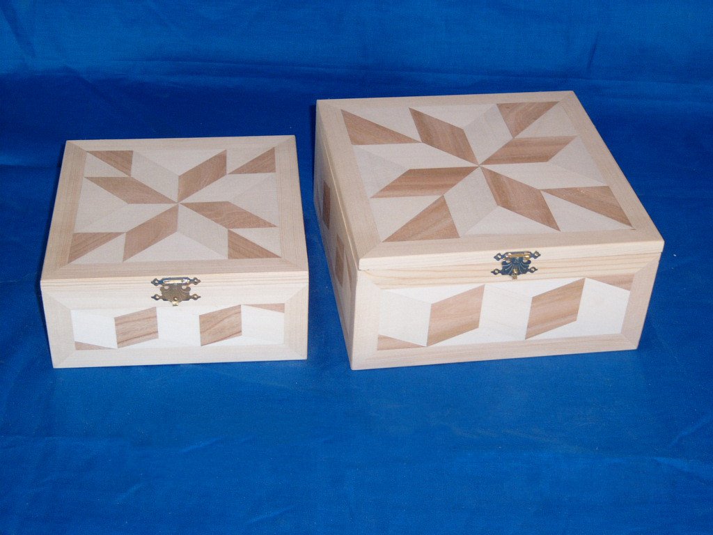 Set of two natural-pine wooden boxes with eight-pointed star inlay pattern on lids and side panels, bronze latches