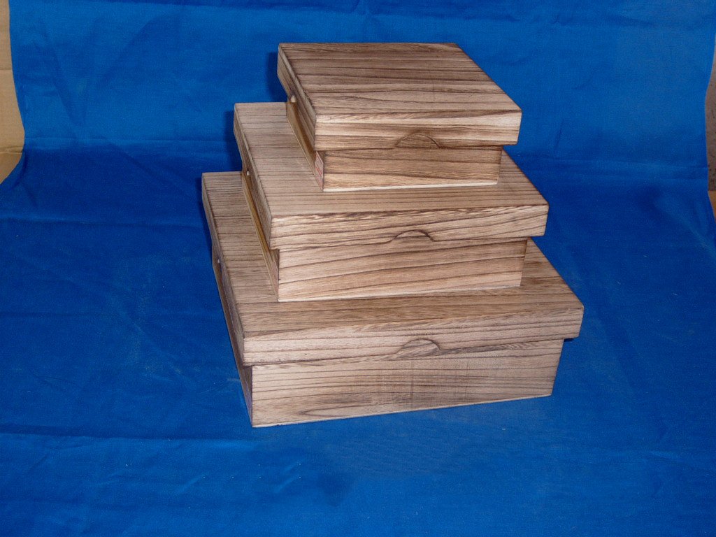 Three-tier nested rectangular wooden box set in medium oak / walnut finish with side rope handles