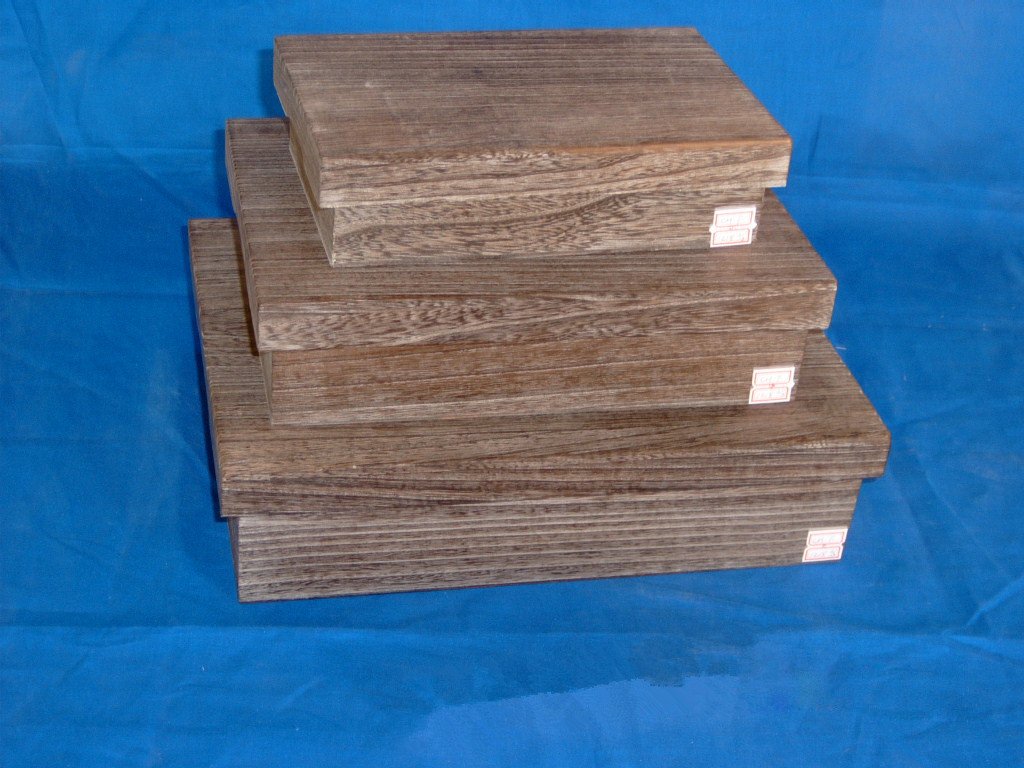 Three-tier nested rectangular wooden box set in oak wood with small product labels on each tier