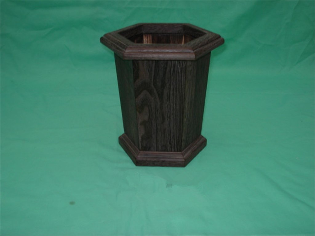 Tall hexagonal wooden flower pot in dark stained finish with stepped base