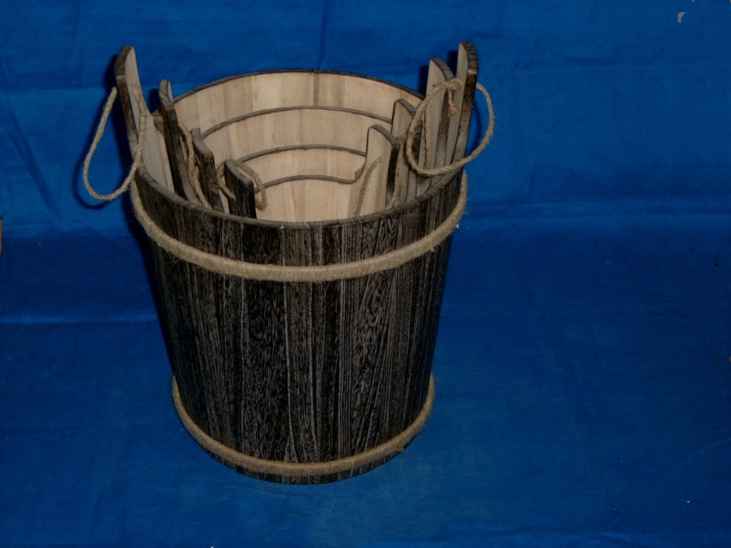 Round slatted dark burnt-wood wooden flower pot with rope handles and rope trim