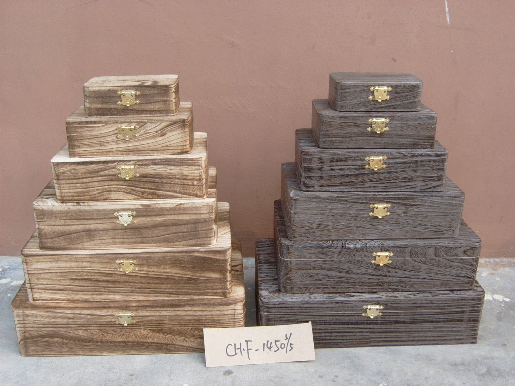 Five-step wooden storage chest set in light wood and dark ash finishes with brass latches