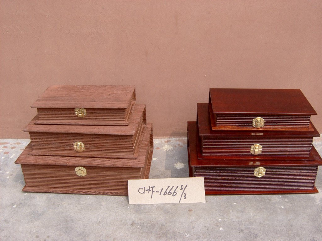 Three-piece ribbed wooden storage chest set in medium brown and dark red with gold latches
