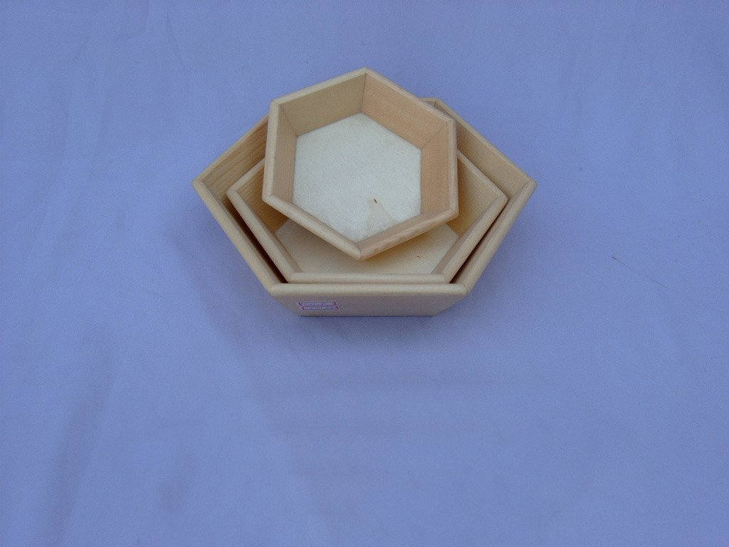 Set of three small nested hexagonal wooden serving trays in natural wood finish