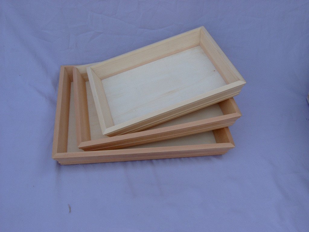 Set of three nested rectangular wooden serving trays with raised rims