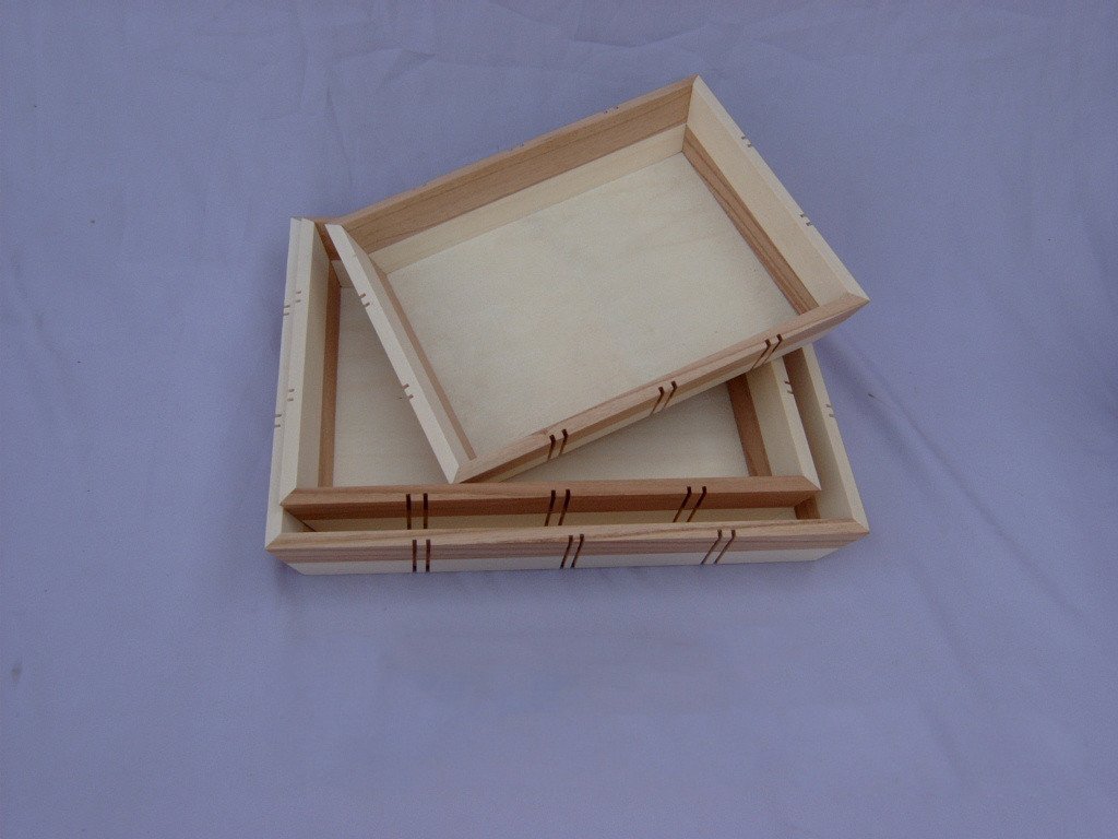 Set of two rectangular wooden serving trays with raised rims and visible peg/joinery details