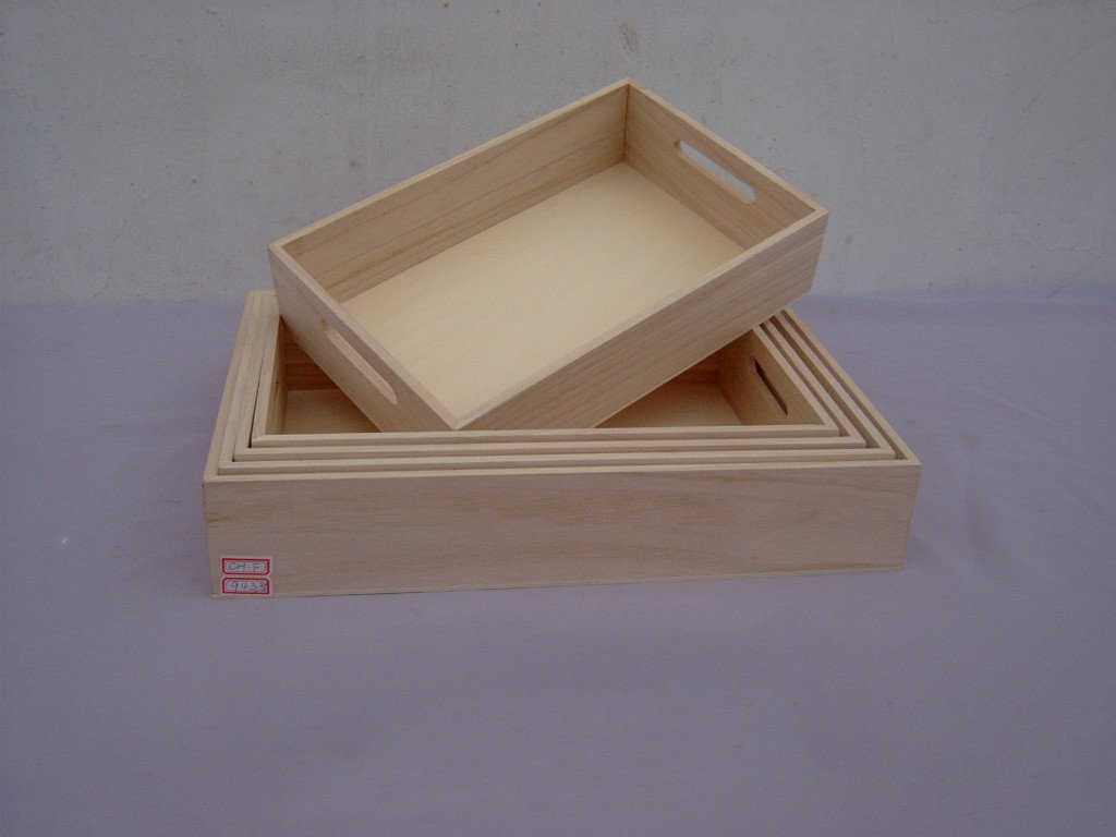 Set of four nested rectangular wooden serving trays with side cutout handles