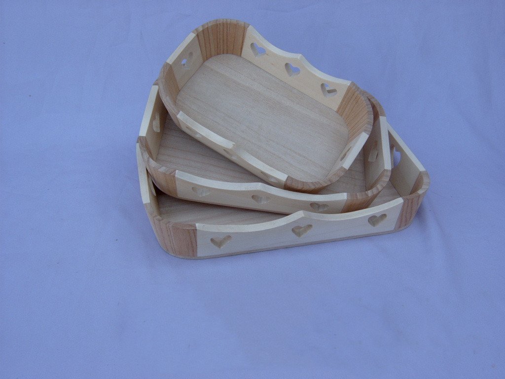 Set of two oval wooden serving trays with heart cutout pattern and alternating light/dark wood rim