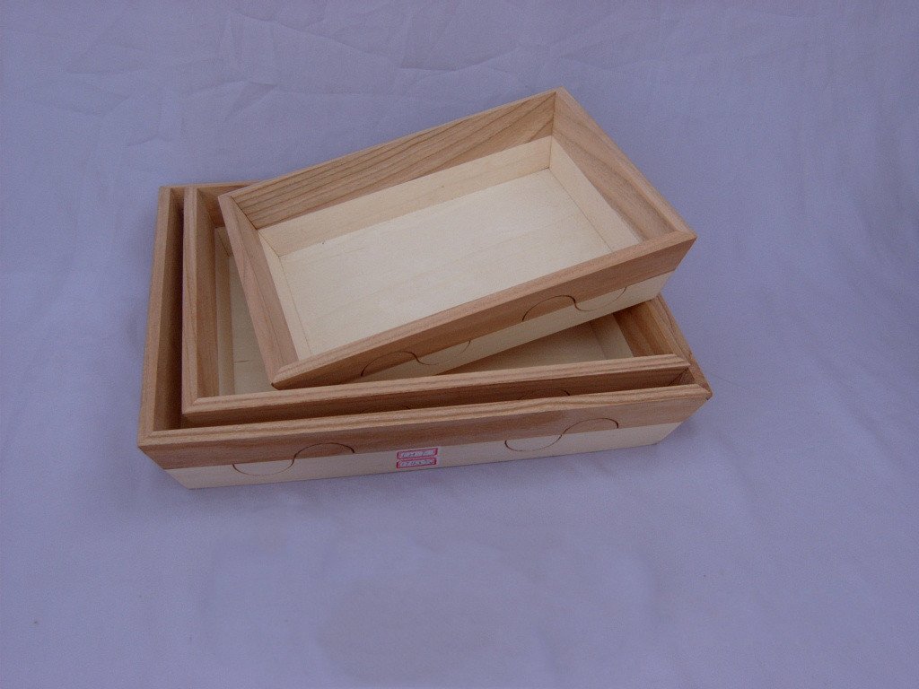 Set of three nested rectangular wooden serving trays with lid and decorative cutout sides