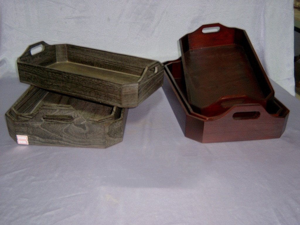 Set of four octagonal wooden serving trays in dark grey finish with side handles