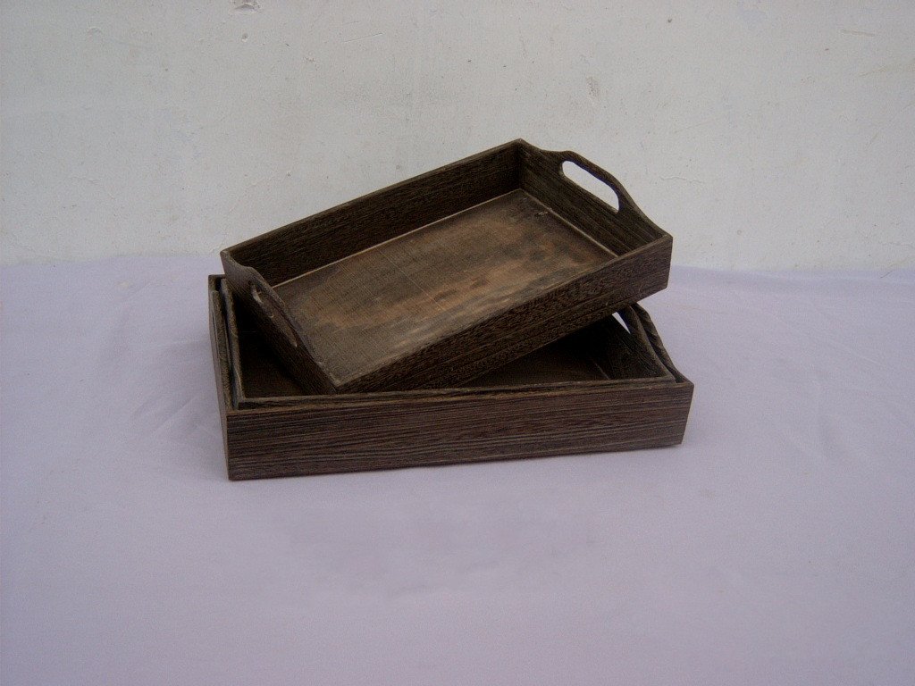 Set of two rectangular wooden serving trays in dark burnt-wood finish with cutout handles