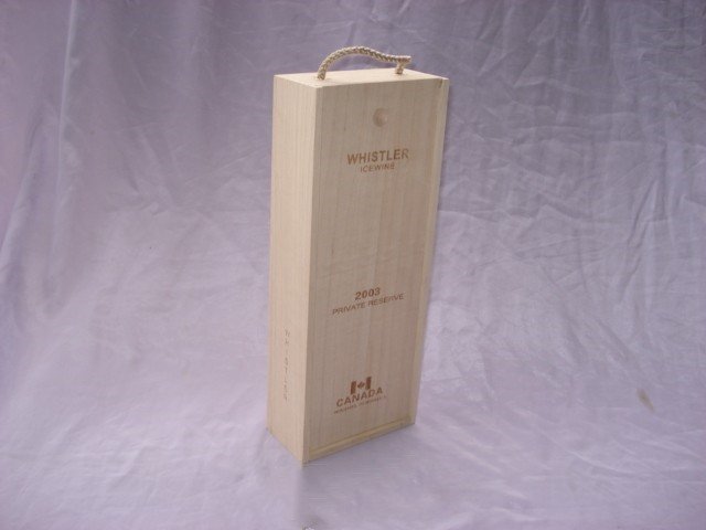 Tall single-bottle natural-pine wooden wine box with rope top handle, WHISTLER ICEWINE 2003 engraved text and Canada logo