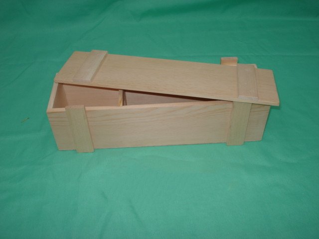 Open long flat natural-pine wooden wine box showing sliding lid and internal divider, finger-jointed corners