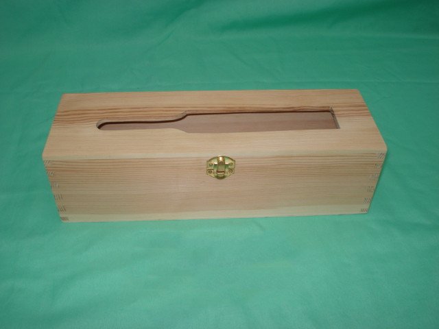 Long flat rectangular natural-pine wooden wine box with bottle-shaped window on lid, finger-jointed corners and brass latch