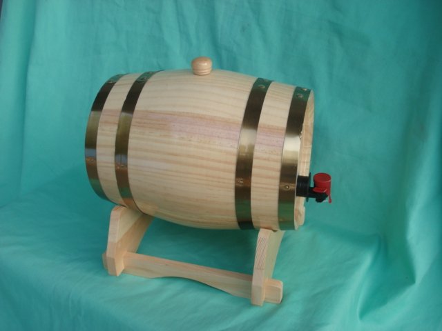 Horizontal wooden barrel-shaped wine box on wooden stand with brass bands, wooden stopper top and red dispensing tap